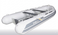 A white inflatable dinghy with gray side stripes and black interior seating, shown on a clean white background. The side of the boat reads 'ZAR mini' and 'RB 12'.